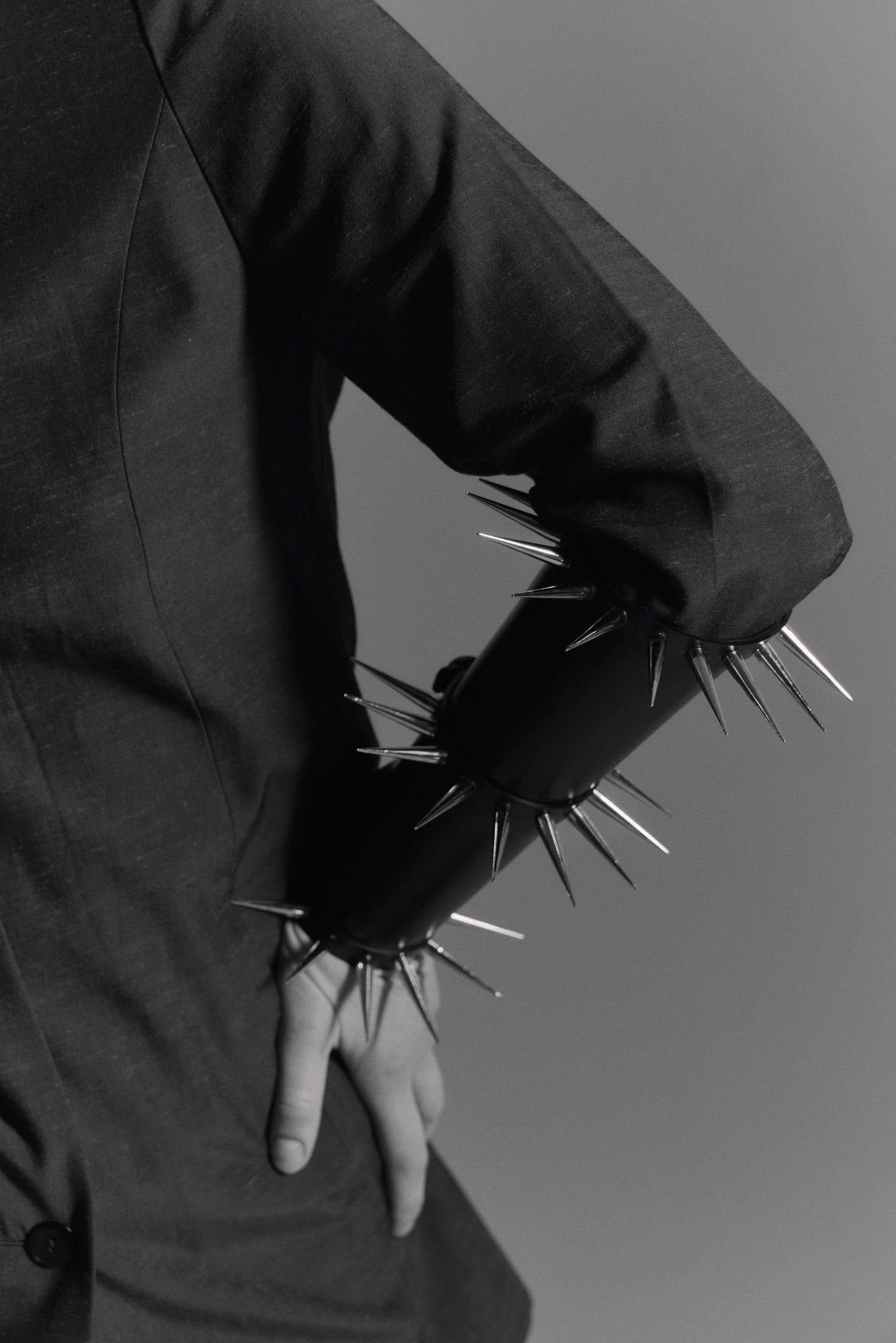     Minimalist black statement arm cuff with polished spikes and premium stainless steel hardware by Klets
