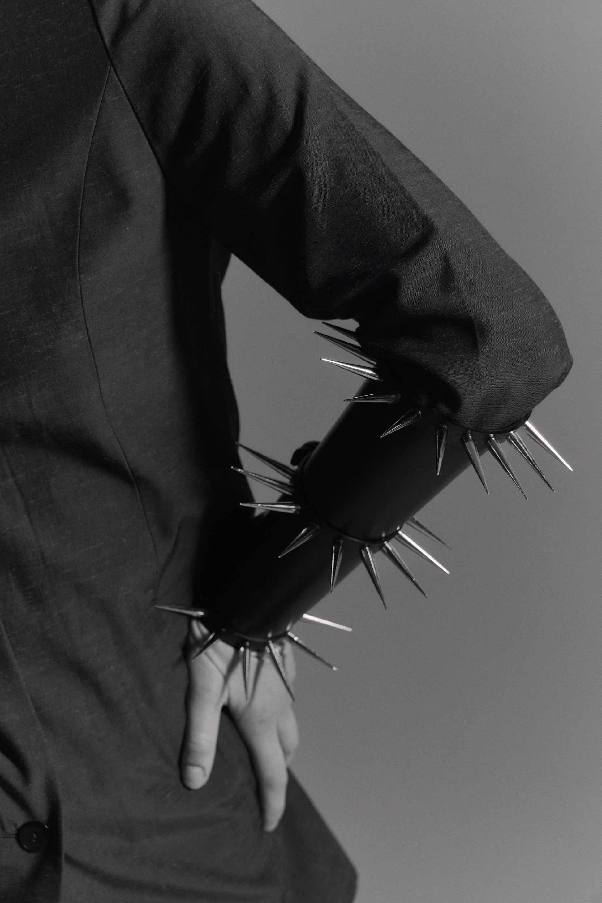     Minimalist black statement arm cuff with polished spikes and premium stainless steel hardware by Klets